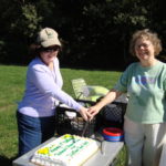 Waltham Land Trust vice president Diana Young (left) and Belmont Citizens Forum board member Sue Bass cut a joint 10th anniversary cake, September 2009.