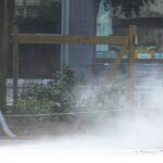 A gas powered leaf blower blowing dust around